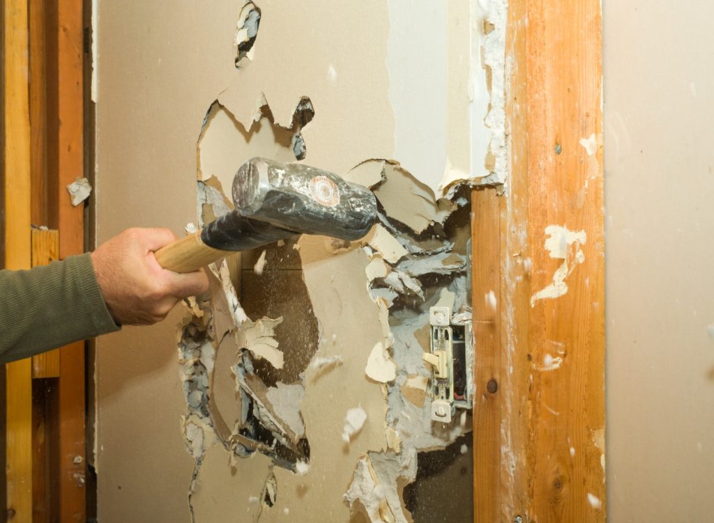 renovating-wall-removing-drywall-with-a-sledgehammer.jpg_s=1024×1024&w=is&k=20&c=2lfTst0iVl_ItVie4c0AZoGRz5AstxRqOo_vfOaMb6A= Man demolishing drywall with sledgehammer